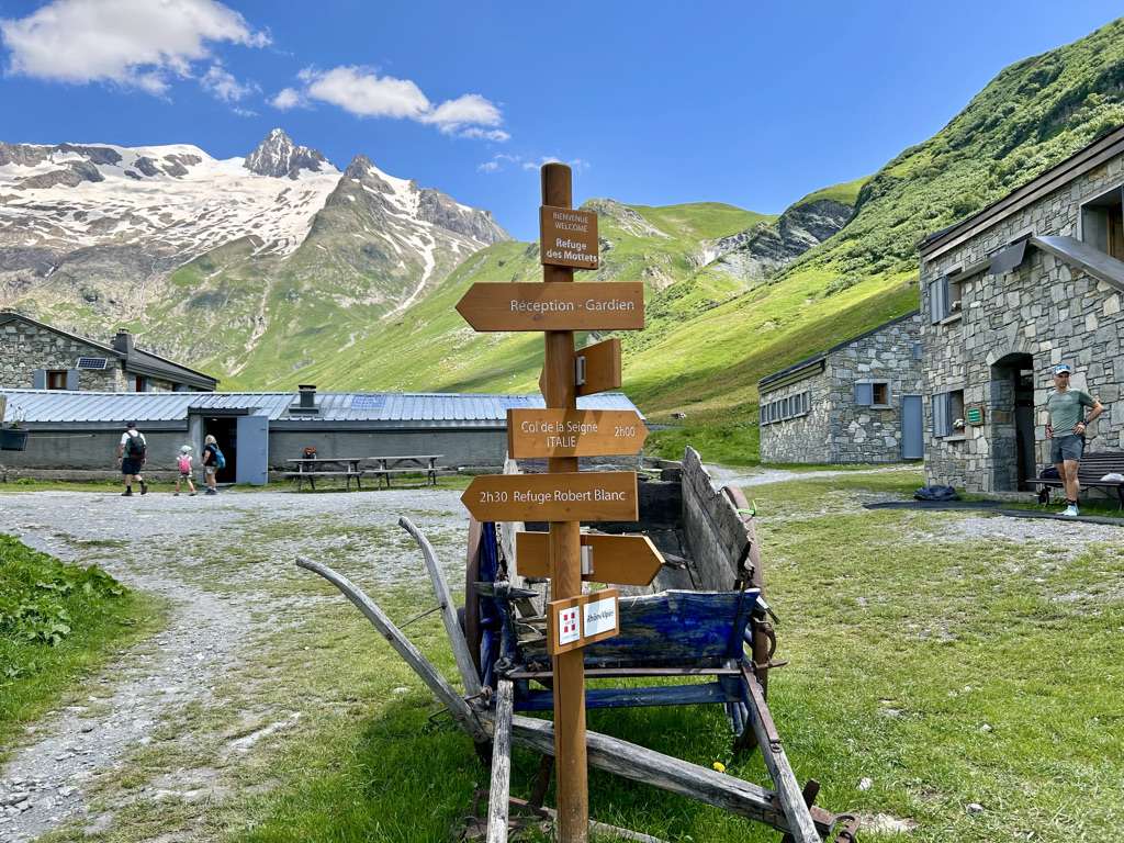 Trail signs for the tour du mont blanc outside refuge des mottets