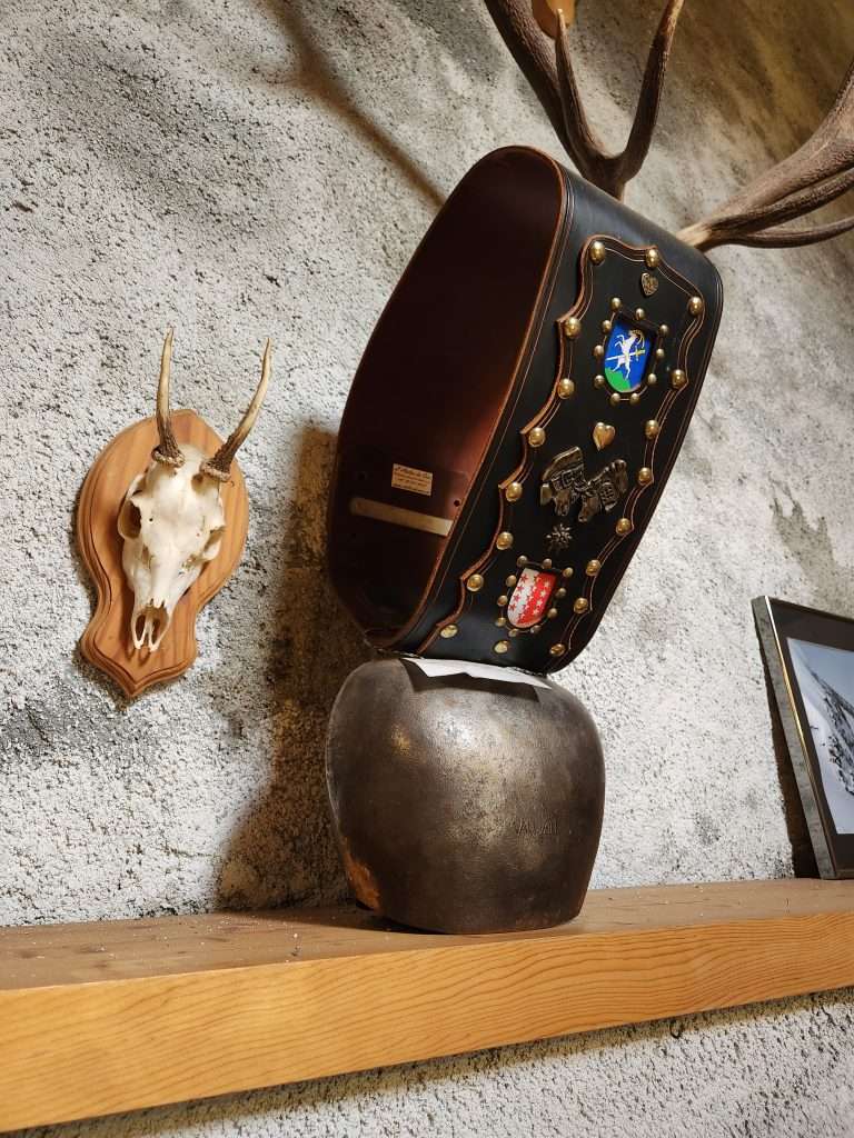 a large cowbell hangs on the wall