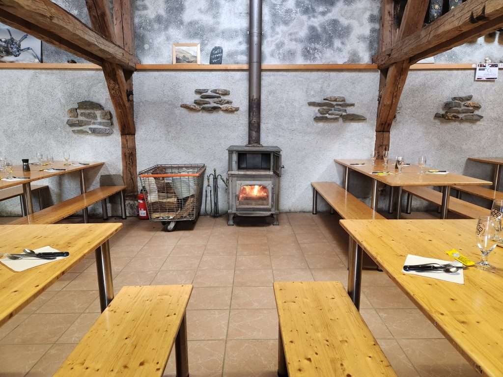 A fireplace warms the dining room at alpage de la peule