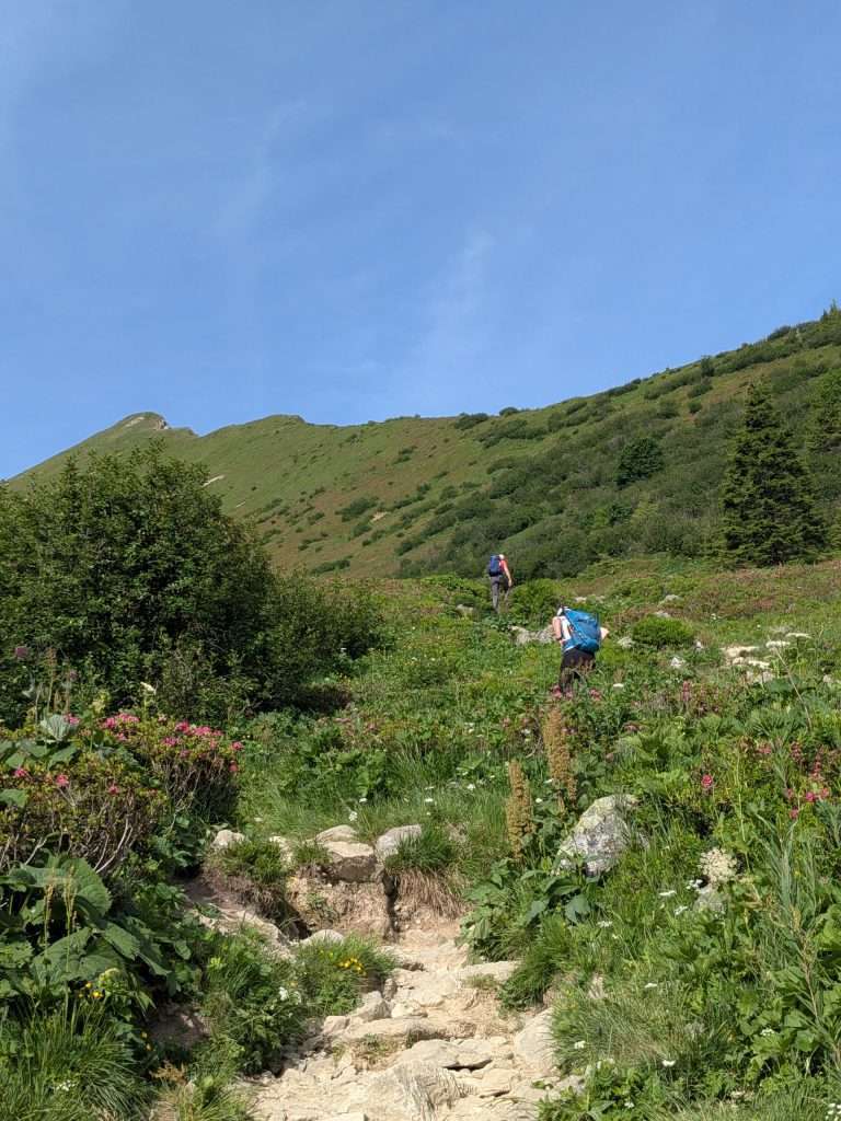 hikers climb towards the col de tricot