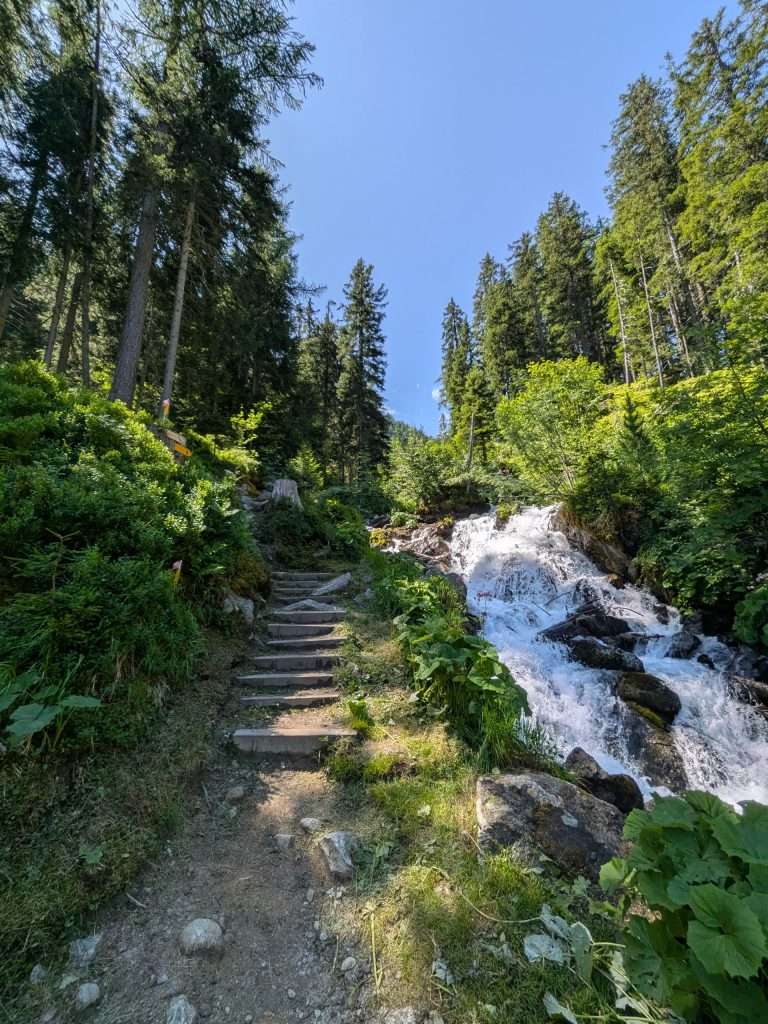 The fenetre d'arpette trail near a small waterfall.