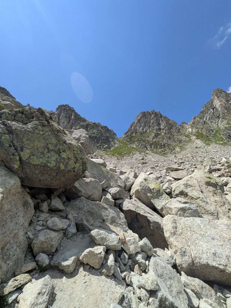 Steep boulders with the pass visible.